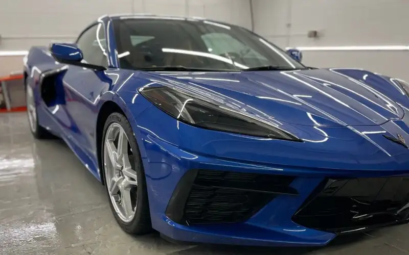 Blue Corvette with a glossy ceramic-coated finish in the studio bay