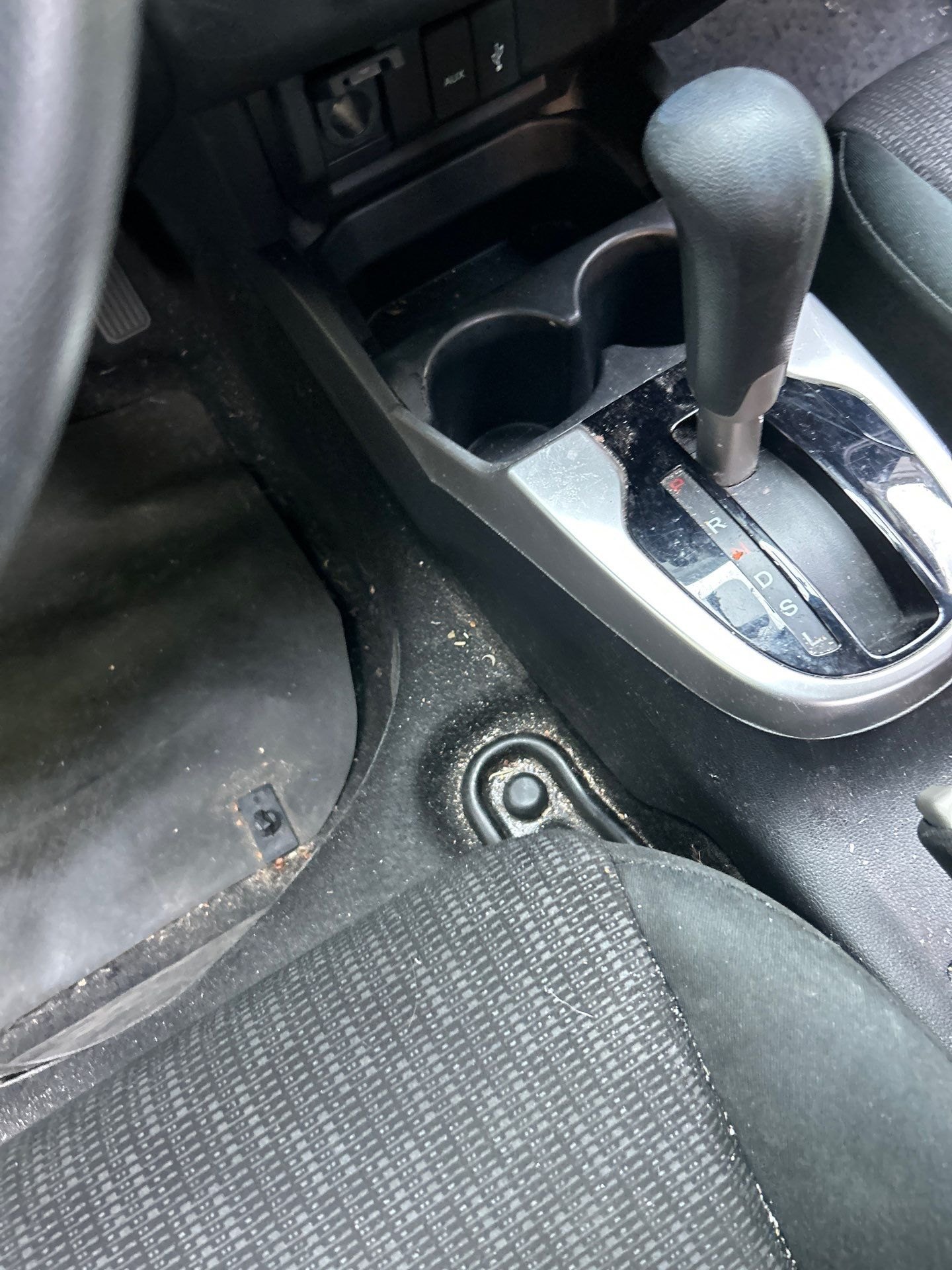 Before: dusty centre console and gritty carpet in a Honda Fit