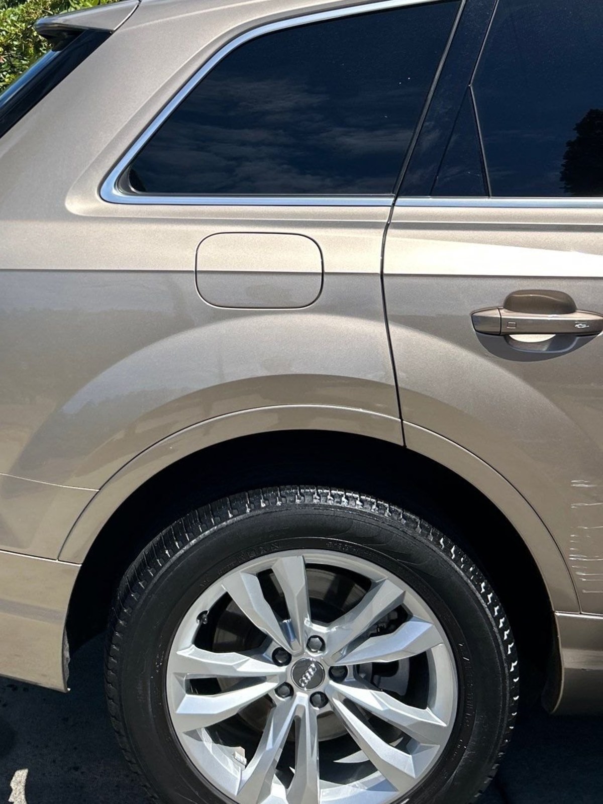 Close-up of an Audi Q7 rear door and cleaned wheel after an Eco Car Cafe exterior detail