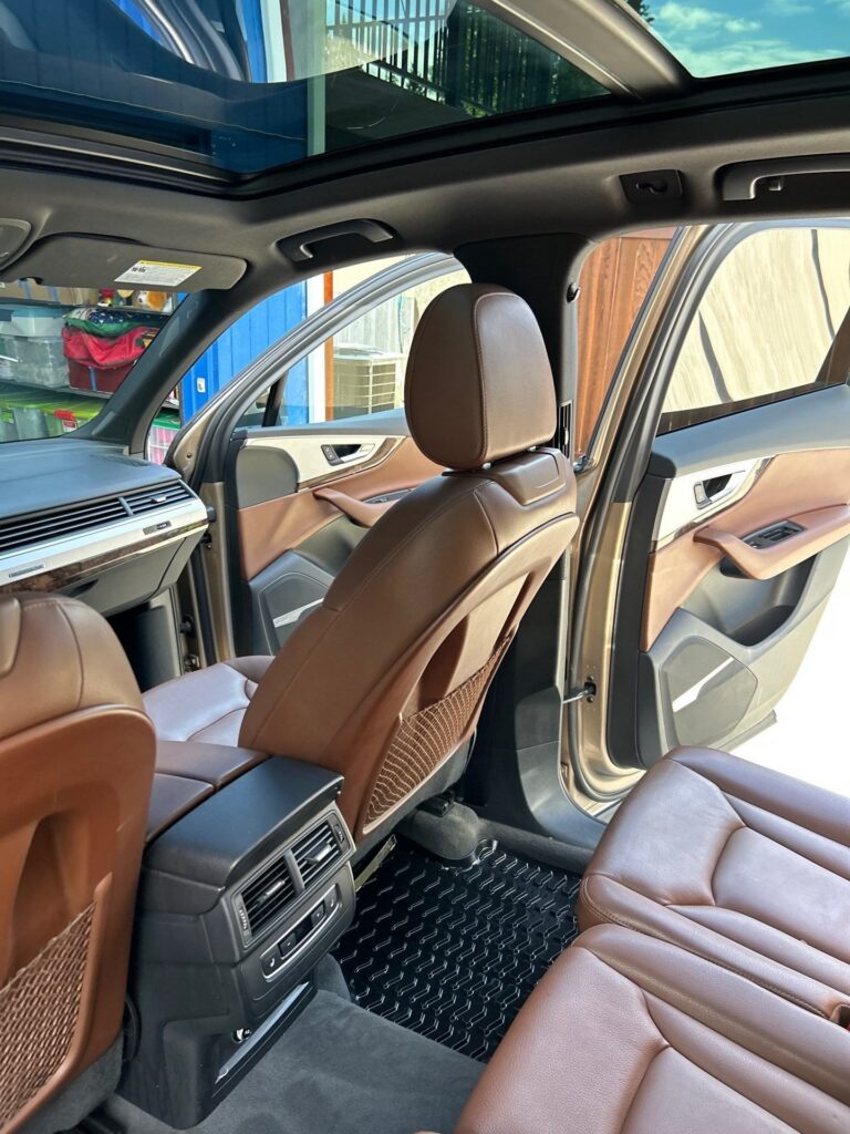 Cognac leather front seats and door panel of an Audi Q7 after an Eco Car Cafe interior detail