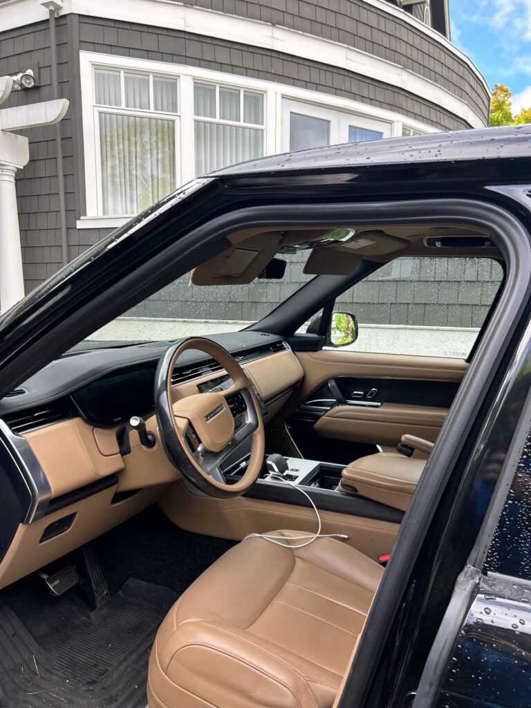 Cleaned and conditioned tan leather dashboard and steering wheel inside a Range Rover