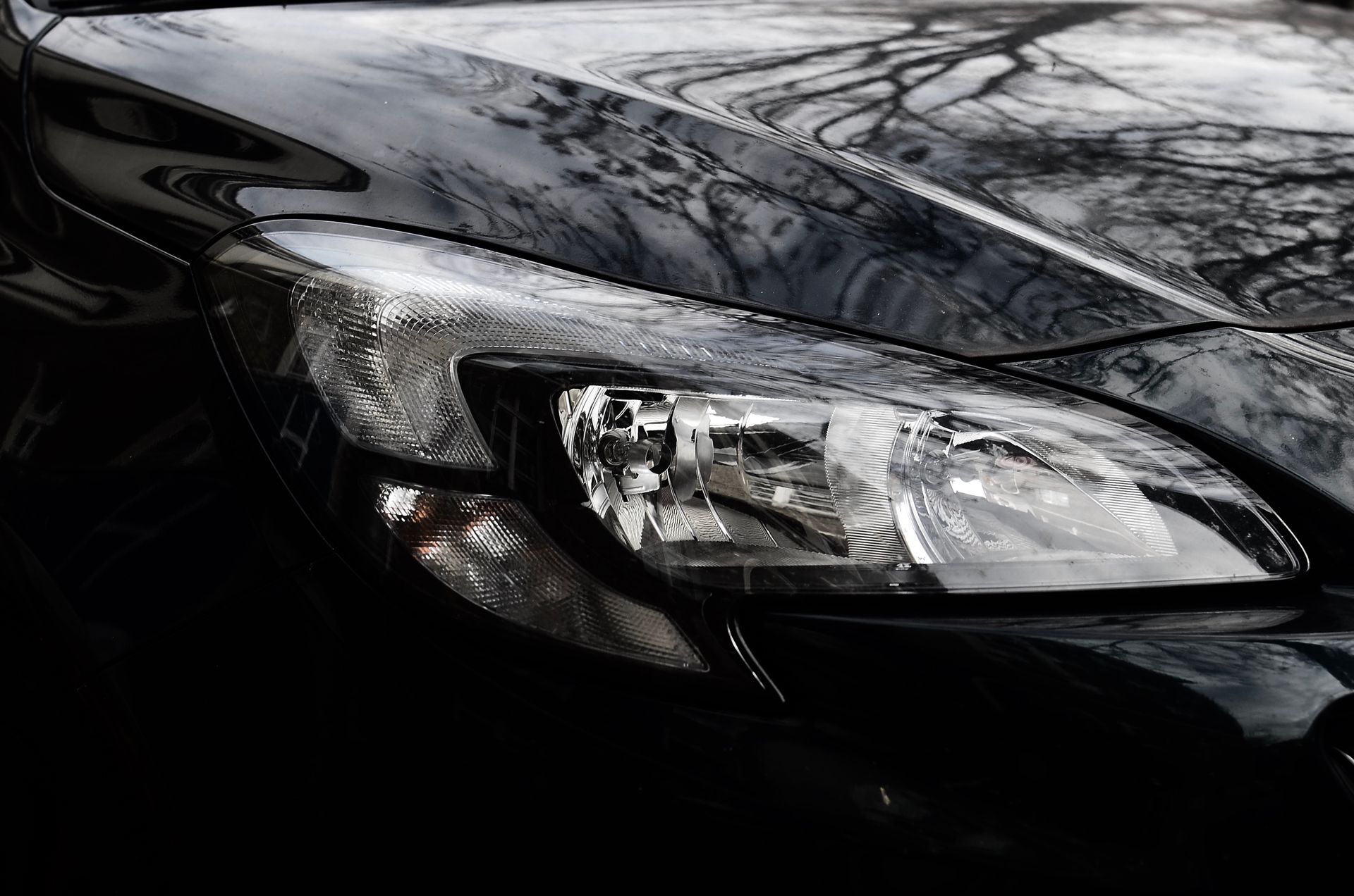 Flawless glossy black hood and headlight protected by paint protection film