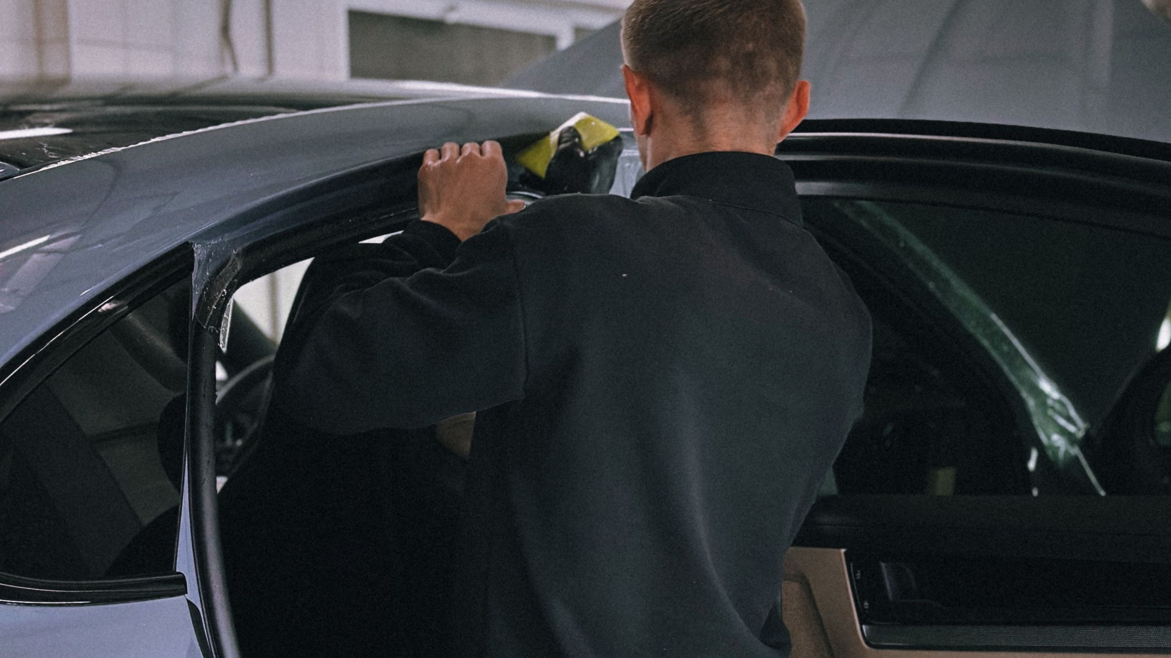 Window tint being installed on a vehicle door glass